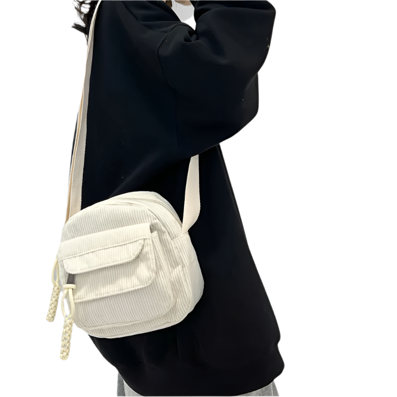 Dames crossbodytas met gebogen klep en ritsvak