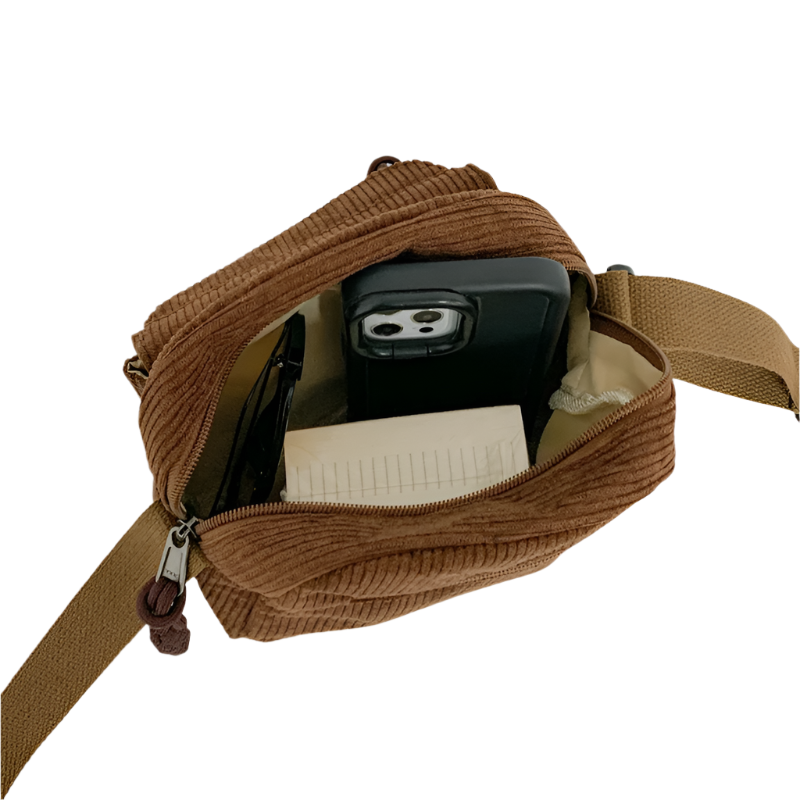 Dames crossbodytas met gebogen klep en ritsvak