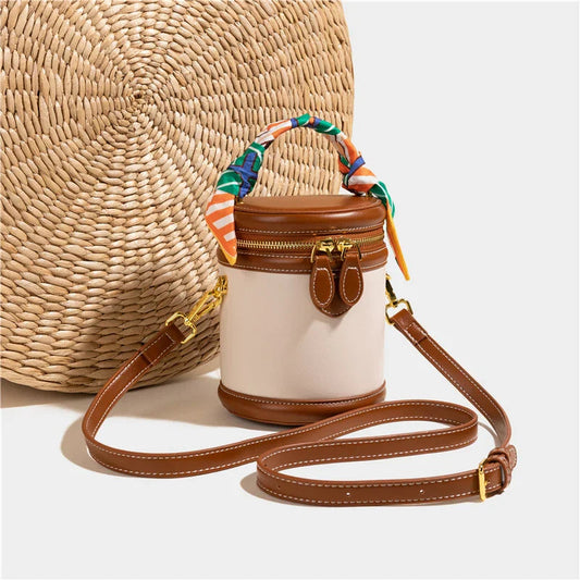 Dames bucket bag met sjaalhandvat en goudkleurige accenten