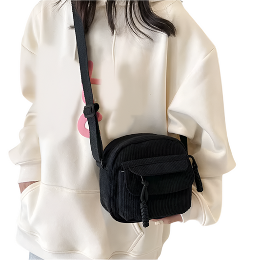 Dames crossbodytas met gebogen klep en ritsvak